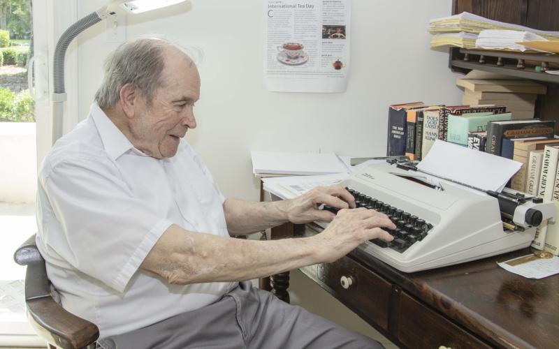 Fred Hill sits at his typewriter in his room at Magnolia Manor Senior Living in 2022. Hill, 88, was a longtime columnist for the Southeast Georgian and the Tribune &amp; Georgian.
