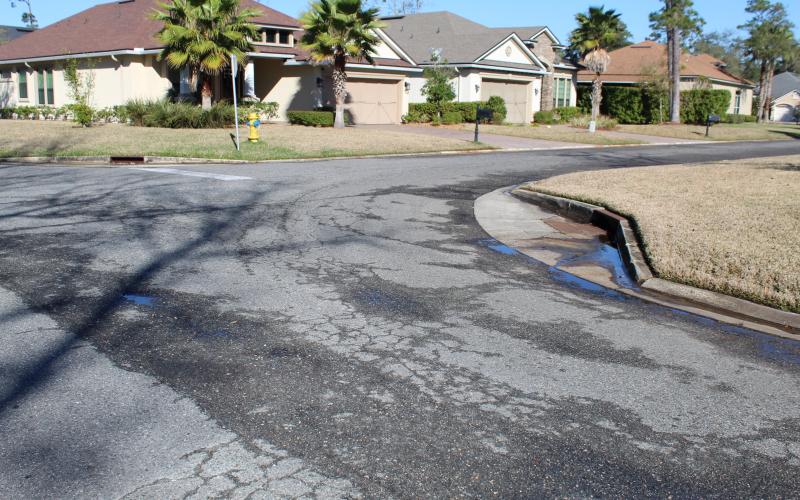On a sunny, dry day, there is water seeping out of the pavement on Spanish Way in the Isle de Mai subdivision. The city of Fernandina Beach filed a lawsuit against CPH Engineering, claiming the company built the road too low, causing water to damage the street. CPH offered the city $80,000 in cash and in-kind services to settle the matter, which the City Commission rejected.