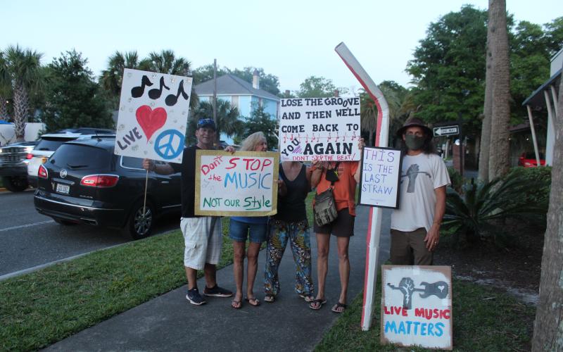 Picketers stood outside Fernandina Beach City Hall Tuesday as the City Commission discussed changes to the city’s noise ordinance. Some speakers at the meeting said they want a committee created to help craft an ordinance that would work for musicians, business owners and residents.
