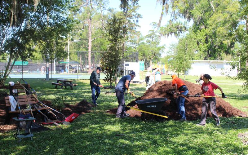 Volunteers spread mulch and put finishing touches on Volunteers Grove, a garden in Central Park honoring volunteers in the community that will be dedicated Thursday.