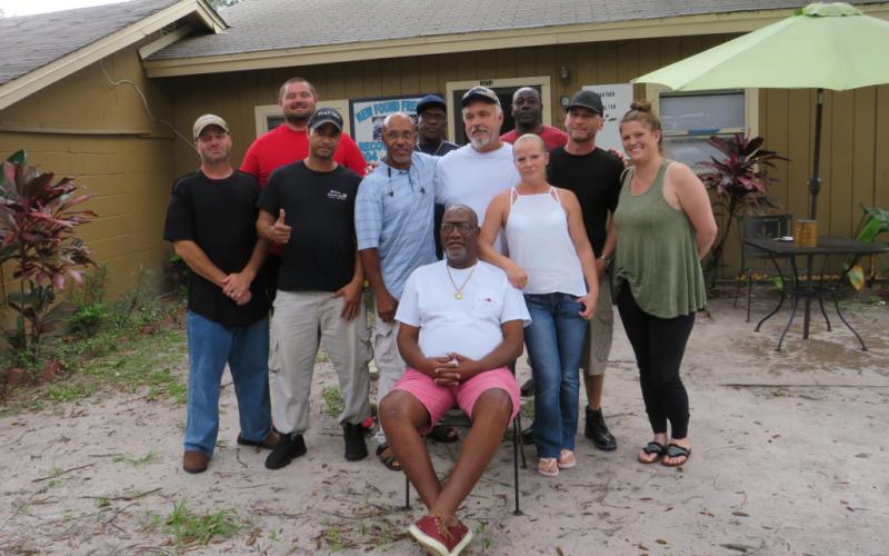 Henry Green sits surrounded by some of the people he has helped through the Grace and Gratitude Sober Living program. He and Dr. Jeff Blyth are both recovering addicts and fighting the city of Fernandina Beach to keep the four houses that comprise Grace and Gratitude’s facilities open. JULIA ROBERTS/NEWS-LEADER