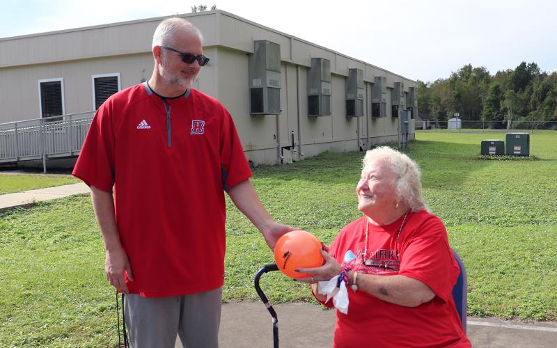 Gabe Whittenburg, Hilliard Parks and Recreation Department director, visits with Silver Sneakers participant Patricia Bobbitt.