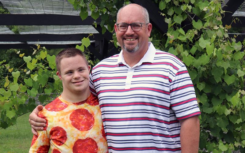 West Nassau High School junior Max Lucovsky joins his dad, Jeff, in their backyard. The teen turns 18 Saturday. Photo by Kathie Colgrove