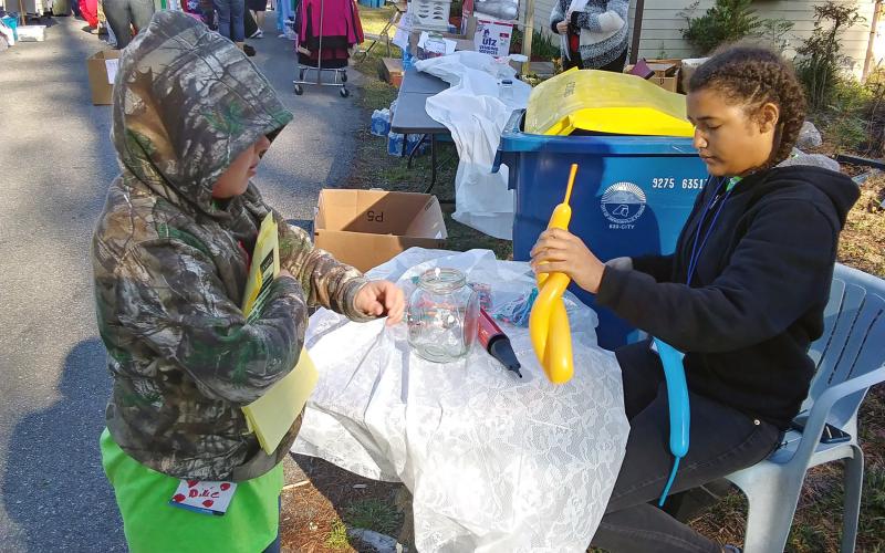 Cousins Dixie Conekin and Aliya Works volunteer at the Be the Change Northeast Florida, Inc. clothing giveaway Saturday. The duo assists at the non-profit’s events often.