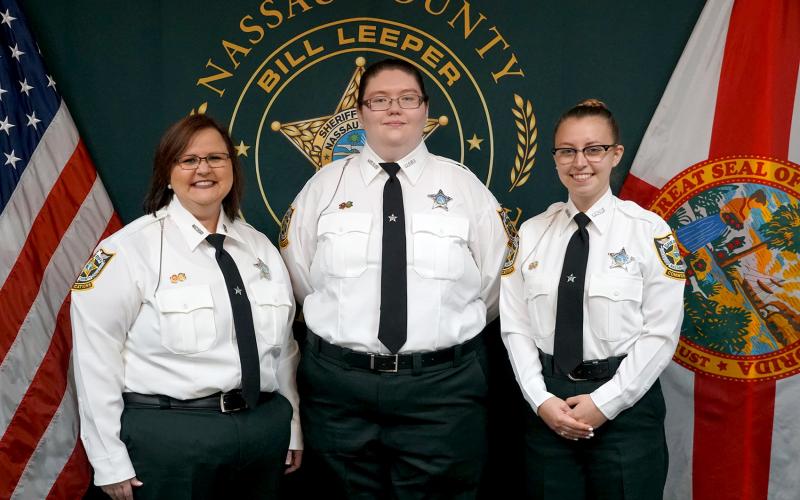 Stephanie Knagge, April Persinger and Alexis Baird pose after swearing in as new dispatchers with the Nassau County Sheriff’s Office.