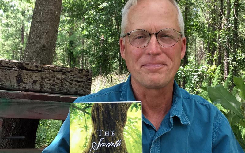 Mike “MJ” Gaylor showcases his novel. He will have a booth at the Callahan Community Market Saturday, 10 a.m. to 2 p.m. at the Callahan Depot. Photo by Lorelai Bryan Photography