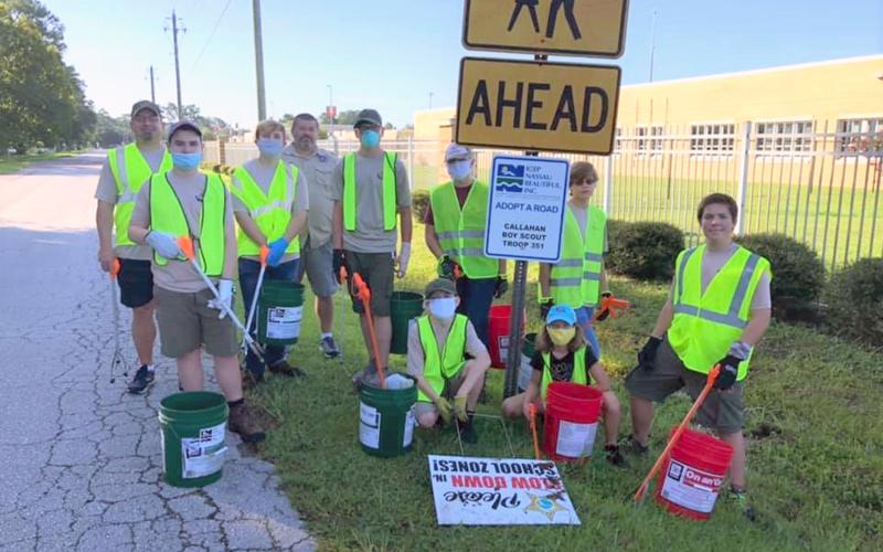 Boy Scouts and leaders from Callahan Boy Scout Troop 351 wear safety vests, gloves and masks for their first Adopt-a-Road clean-up event. They collected more than 175 pounds of litter and debris during their first clean-up event.