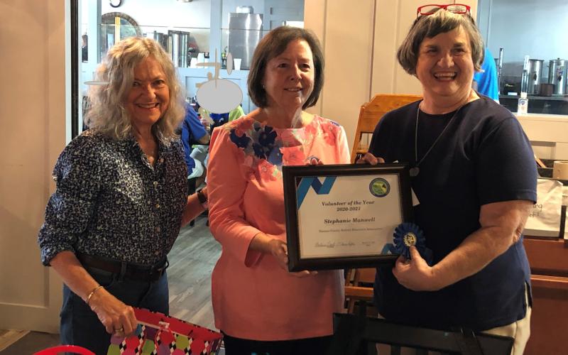 Nassau County Retired Educators Association Volunteer Coordinators Elaine Rafter, from left, and Barbara Leech present the Volunteer of the Year Award to Stephanie Manwell for outstanding service to the community.