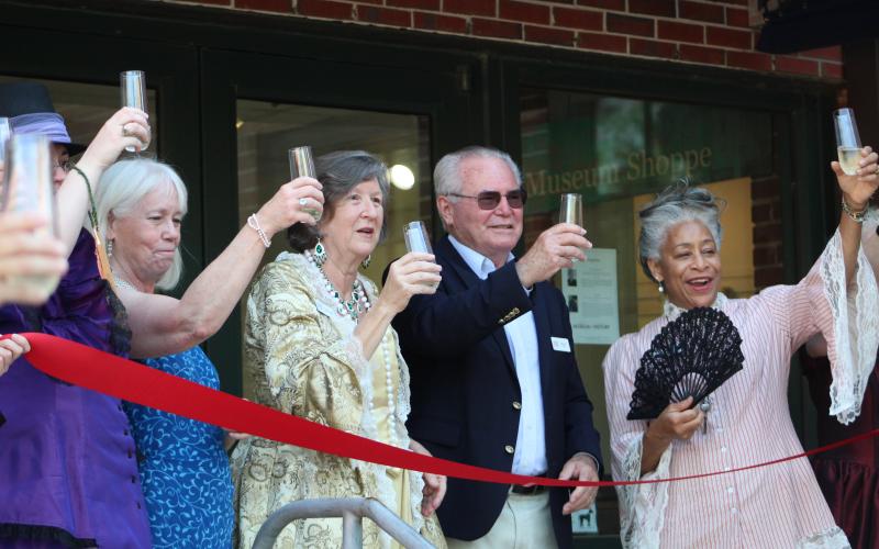 Amelia Island Museum of History employees and board members toast the grand reopening of the museum.