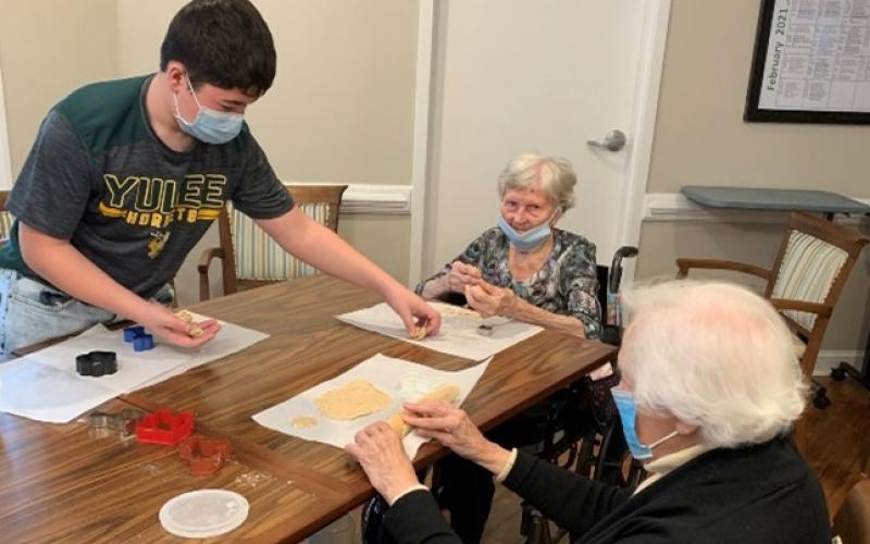 Yulee Middle’s Asher Conway spends time with assisted living residents at Osprey Village.