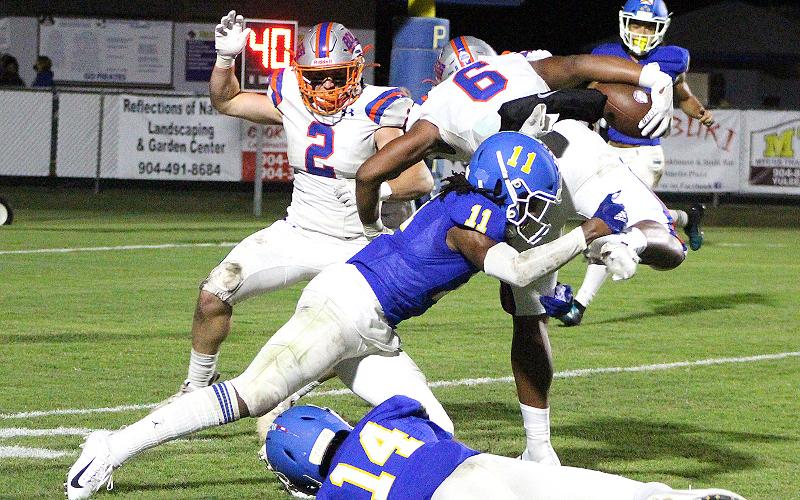 Willie Coleman and Andre Lucas try to tackle a Bulldog. BETH JONES/NEWS-LEADER
