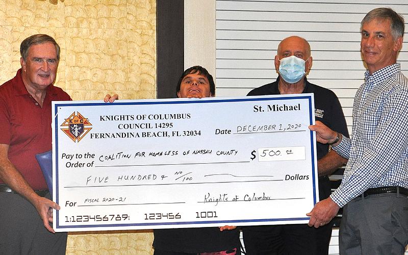 Knights Bob Gerth, Breant Dickerson and Kenny Dalton present a check to Mark Avakian of the Coalition for Homeless of Nassau County. JACK DEACON/SPECIAL