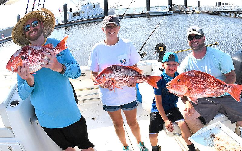 William Boyle, Julie, Breck and William Benton with a nice catch of red snapper, left. Capt. Bryce Schmidt cleans a nice catch of red snapper, right. TERRY LACOSS/SPECIAL
