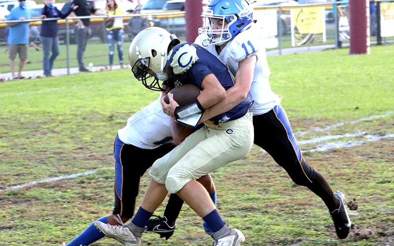 Fernandina Beach Middle School’s Devin Murray and Alex Pulwicz wrap up a Callahan Middle School football player Tuesday night in Callahan. AMANDA REAM/COMMUNITY NEWSPAPERS INC.