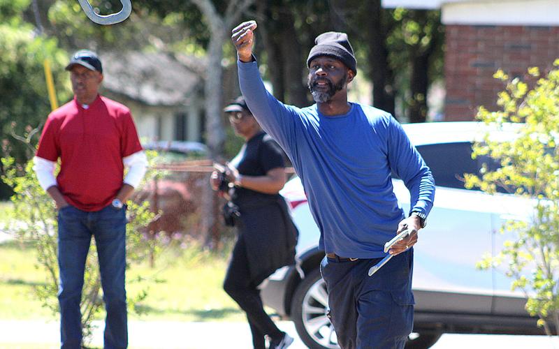 Teddy White competes in the inaugural horse shoe tournament Saturday at the MLK Jr. Center. He and teammate Everette Way took first place.