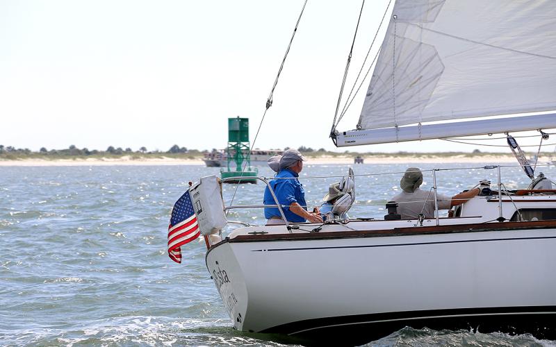 Sea Esta skipper Glen Stettler, at the helm on left, and crew keeping an eye on traffic and markers along the race course on Saturday.