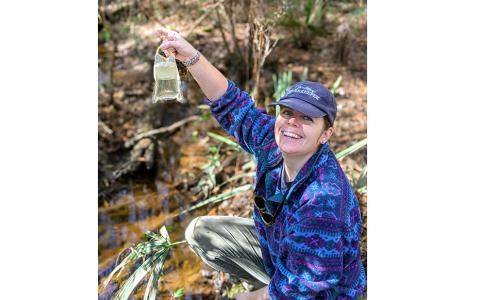 St. Mary’s Riverkeeper Anna Laws shows off the clarity of the water at Horsepen Creek. (Photo by Kendra Shafer)