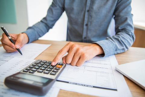 Citizen figuring taxes with a calculator