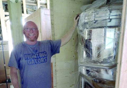 Brackish Beer Company's Jon Preble shows off a piece of equipment that will be used to brew beer in the craft beer joints new location on Osborne Street.