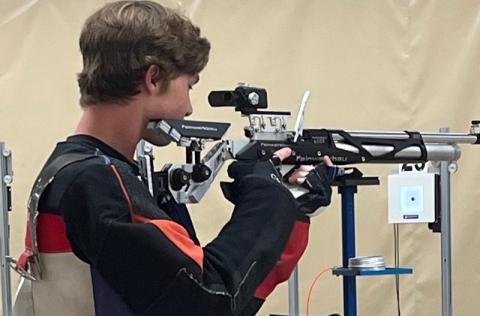 John Strassner takes aim during a riflery camp in Alabama. (Submitted photo)