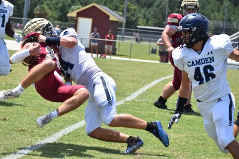 Camden County’s Ian Pederson tackles Ashley Ridge’s Quentin Birk.