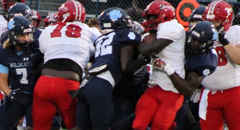 Glynn Academy running back Greg Peacock finds nowhere to go as several Wildcats converge on the tackle. (Andy Diffenderfer, Tribune & Georgian)