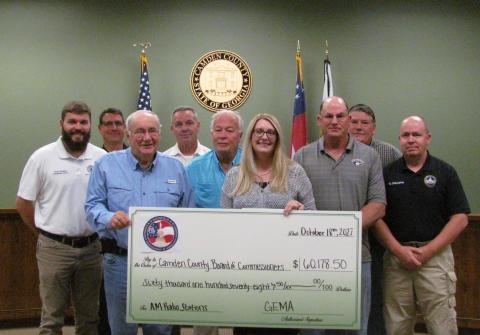 Camden County commissioners celebrate a grant award with Camden County Radio System Administrator Bill Carreira, EMA Director Chuck White, Grants Manager Julie Haigler and EMA Deputy Director Troy Johnson.