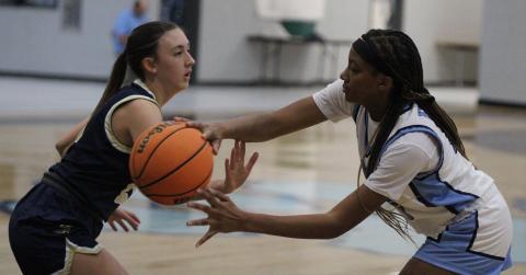 The Lady Wildcats’ Dasmine Cooper tries to pass around a Brantley County defender in a preseason scrimmage. (Andy Diffenderfer, Tribune & Georgian)