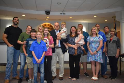 New St. Marys Chief of Police James Galloway celebrates his hire with his family at the St. Marys City Council meeting Monday.