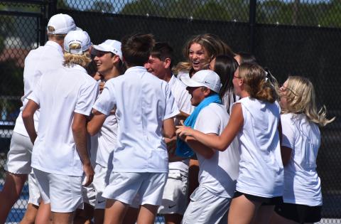 Wildcat tennis players celebrate last Friday after Tyler Klein won the deciding match at No. 3 singles and sealed the boys’ 3-2 second-round Class 7A playoff win over Parkview. (Andy Diffenderfer, Tribune & Georgian)