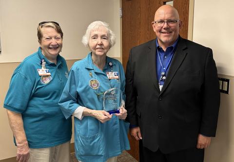 Southeast Georgia Health System Camden Campus Volunteer Services President Kathleen Worthing, left, and Camden Campus Vice President and Administrator Glenn Gann, right, honor the volunteer of the year, Lansie Manning.
