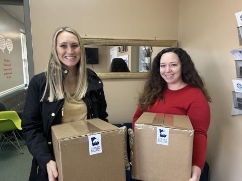 Georgia Cotton Commission Education and Outreach Specialist Caroline Gentry, left, presents Safe Harbor Children Advocacy Center’s Brionna Jones with 125 pairs of socks on behalf of the state’s 3,000 cotton farmers.
