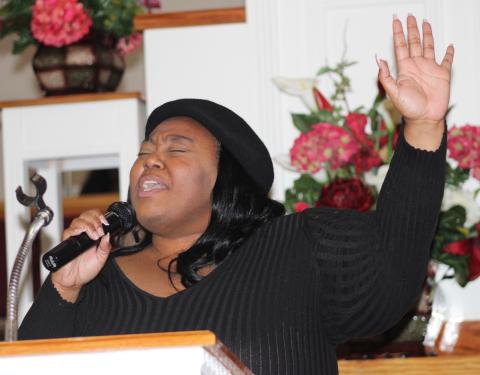 Minga Williams sings Monday during the Martin Luther King Jr. March and Unity Program celebration Monday in Kingsland.