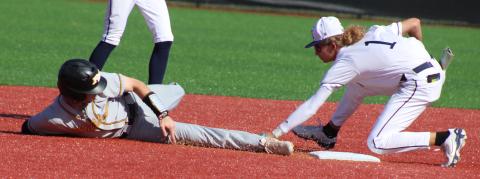 Camden County infielder Gavyn Nelson stretches for a tag attempt on Richmond Hill’s Noah Stone. (Andy Diffenderfer, Tribune & Georgian) 