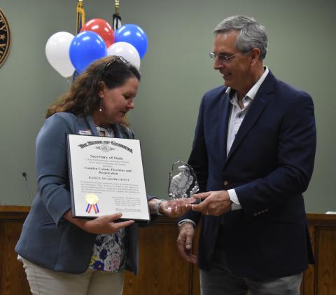 Georgia Secretary of State Brad Raffensperger, right, presents Camden County Election Supervisor Shannon Nettles with the EAGLE Award.