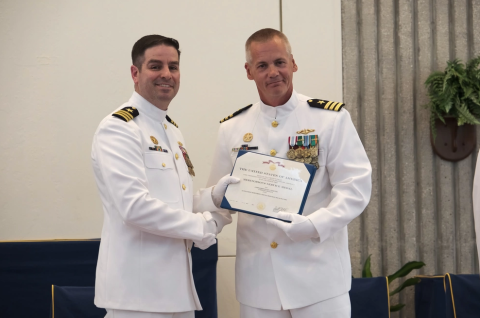 Cmdr. David Burke, deputy commodore, Submarine Squadron 20, right, awards Cmdr. Steven Dykstra the Meritorious Service Medal before relinquishing command of Ohio-class ballistic-missile submarine USS Wyoming (SSBN 742) (Blue) to Cmdr. Robert Moreno, during a change of command ceremony aboard Naval Submarine Base Kings Bay.