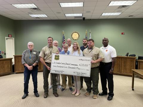 Celebrating the county’s acceptance of grant funds for a Community Wildfire Protection Plan are, from left, Camden County Commissioner Jim Goodman, Community Wildfire Defense Grant Coordinator Anthony English, Commissioners Lannie Brant and Martin Turner, Chairman Ben Casey, Grants Manager Julie Haigler, Commissioner Trevor Readdick, Georgia Forestry Ranger Frank Allen and Camden County Fire Rescue Chief Terry Smith.