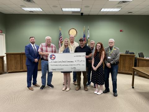 Camden County Administrator Shawn Boatright, from left, Commissioner Lannie Brant, Grants Manager Julie Haigler, Chairman Ben Casey, Maintenance Director Alex Harrellson, Commissioner Martin Turner, Floodplain and Soil and Erosion Coordinator Cassie Turpin and Commissioner Jim Goodman celebrate the county’s hazard mitigation grant.