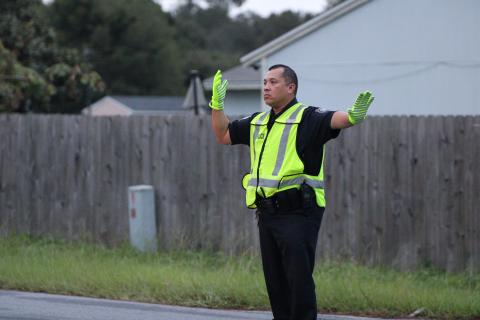 St. Marys Police Department officer Felipe Rivas directs traffic Wednesday morning in front of St. Marys Middle School. Rivas is the school resource officer and works on campus every day.