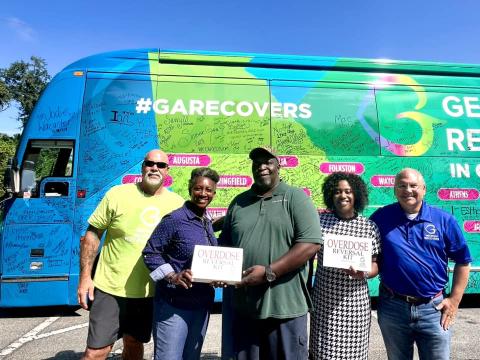 The Georgia Recovers Bus Tour recently visited Woodbine. Georgia Recovers Bus Tour manager Jon Langston, Woodbine Mayor Kizzi Knight, Jimmie Cohen, City Administrator Samantha Jackson and Georgia Council for Recovery policy advisor Jeff Breedlove show off the two Narcan kits donated to the city of Woodbine.