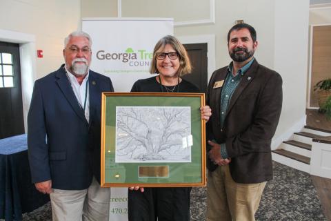 The city of St. Marys recently received the Outstanding Streetscape Revitalization Grand Award for 2024 for its Median Streetscape Pilot Project. From left are Georgia Tree Council President Robert Seamans, St. Marys Tree Board Chairwoman Christine Adamow and Georgia Forestry Commission Director Johnny Sabo.