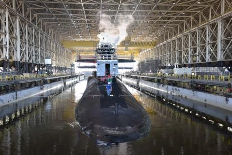 An Ohio-class nuclear-powered ballistic missile submarine (SSBN) enters the Trident Refit Facility Dry Dock for a repair and maintenance period. The dry dock is one of the largest covered dry docks in the world.