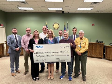 Camden County Administrator Shawn Boatright, from left, Commissioner Robbie Cheek, Communications Director Kristen Kennedy, Chairman Ben Casey, Grants Manager Julie Haigler, Commissioners Cody Smith and Martin Turner, Deputy County Administrator Seth Collins and Commissioner Jim Goodman show off a grant the county received for its internship program.