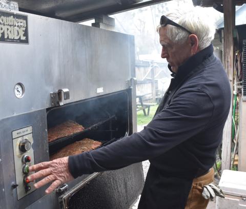 Captain Stan’s Smokehouse’s owner Stan Mieloch smokes some meat last week before the dinner rush.