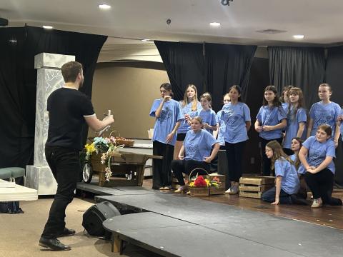 Saltwater Performing Arts’ “My Fair Lady” ensemble members rehearse a number with visiting guest director and Broadway actor Colin Anderson.