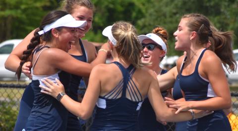 The Camden County High girls tennis team celebrates after defeating MIll Creek in a second-round state playoff Monday. The Lady Wildcats host South Forsyth in a Friday quarterfinal. (Andy Diffenderfer, Tribune & Georgian) 