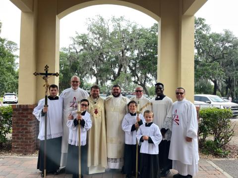 Jared Miller, center, of Woodbine, is studying to be a Catholic priest. The photo was taken at Our Lady Star of the Sea in St. Marys with current pastor Father Mariusz Fuks, Deacons Tim Hughes, Henry Nieves and Paul Lang, and altar servers from the parish.
