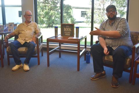 Author Joshua Sharpe, right, talks about his research that helped lead to the exoneration of Dennis Perry, left, who was convicted in the 1985 double murder of Harold and Thelma Swain at Rising Daughter Baptist Church.