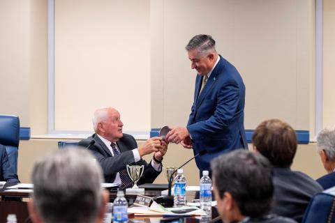 University System of Georgia Chancellor Sonny Perdue, left, presents College of Coastal Georgia President Johnny L. Evans Jr. with the Chancellor’s Cup at the USG Board of Regents meeting in August. 