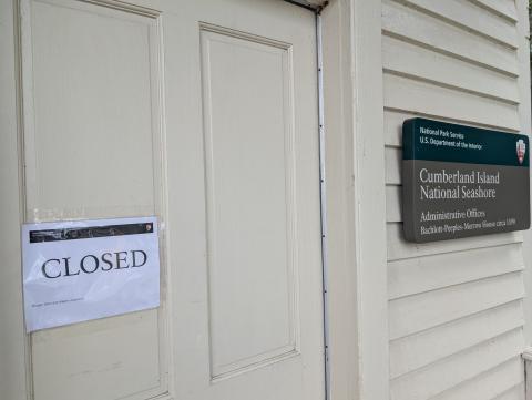 A sign outside the National Park Service’s St. Marys office has a closed sign. Because of the federal government shutdown, Cumberland Island is also not open.